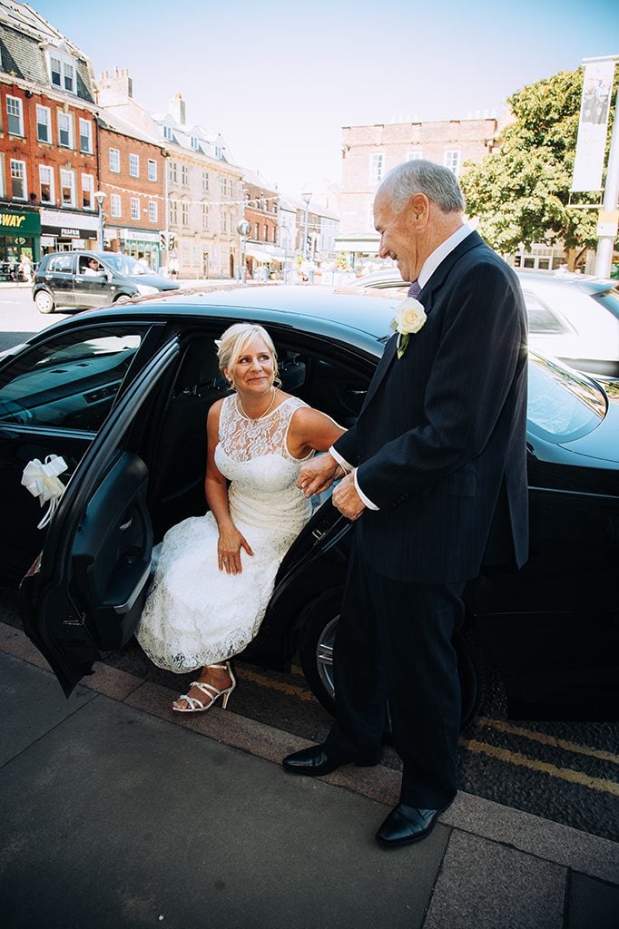 Bride helped from wedding car outside Morpeth Town Hall