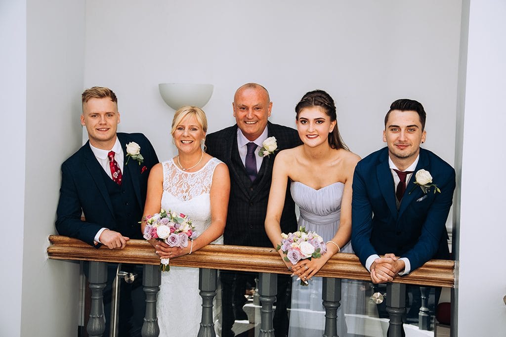 Bride, Groom and family on the staircase balcony, Morpeth Town Hall