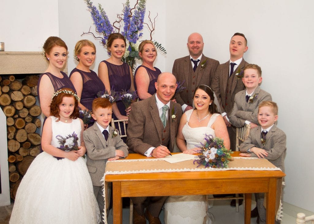 Bridal Party sighing the register in the whiter oom at Brinkburn Priory, Northumberland