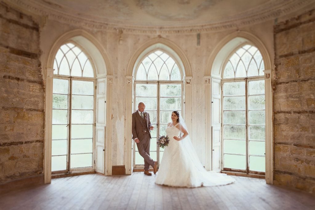 Bride & Groom in front of windows of the manor house at Brinkburn Priory, Northumberland