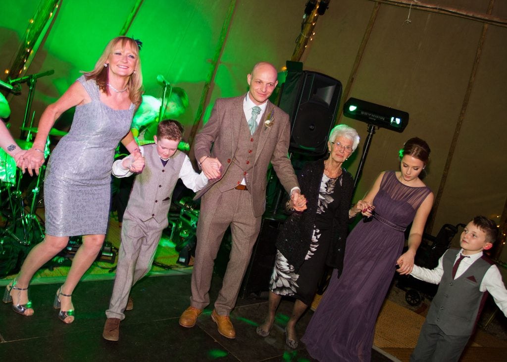 Groom dancing with his family