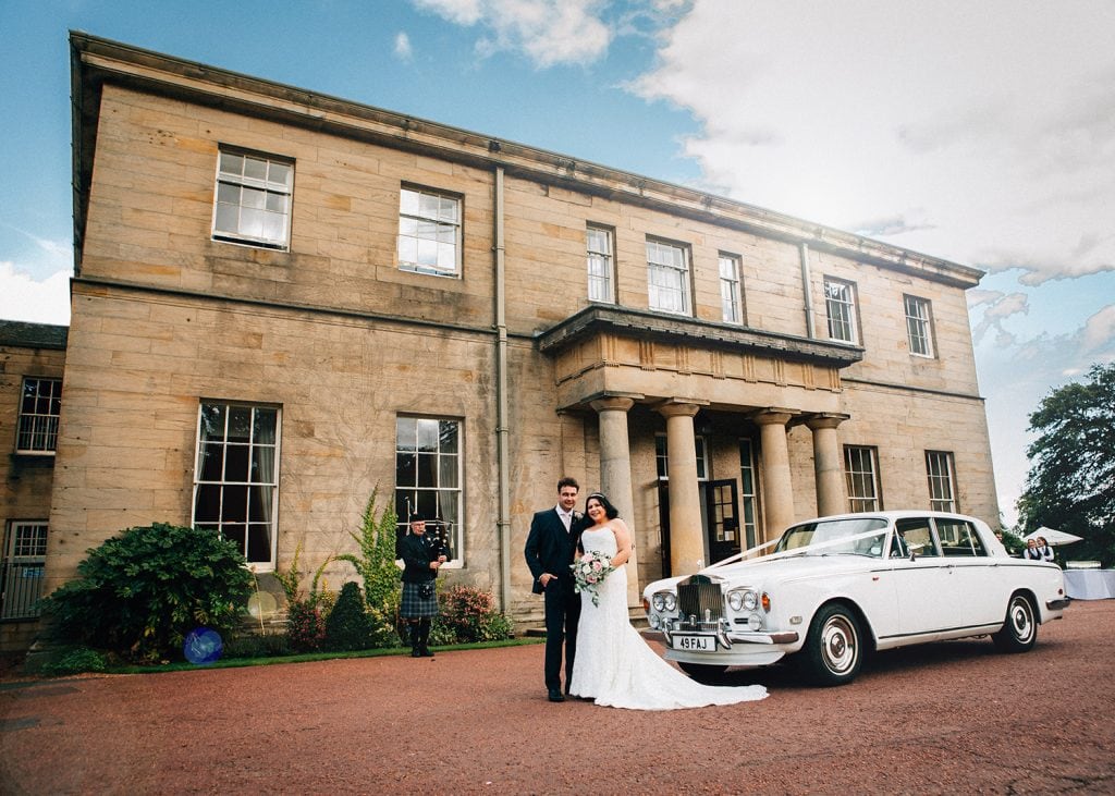 Bride & Groom with their Rolls-Royce in front of Linden Hall in Northumberland