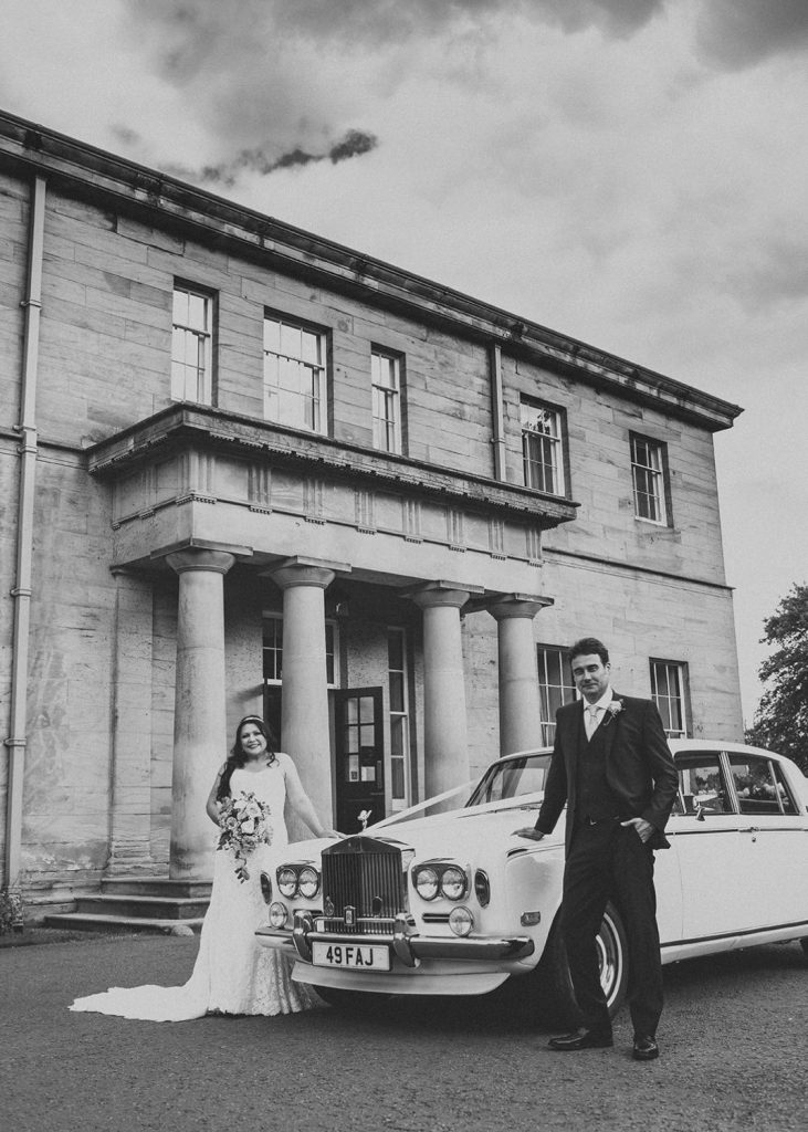 Bride & Groom with their Rolls-Royce in front of Linden Hall in Northumberland
