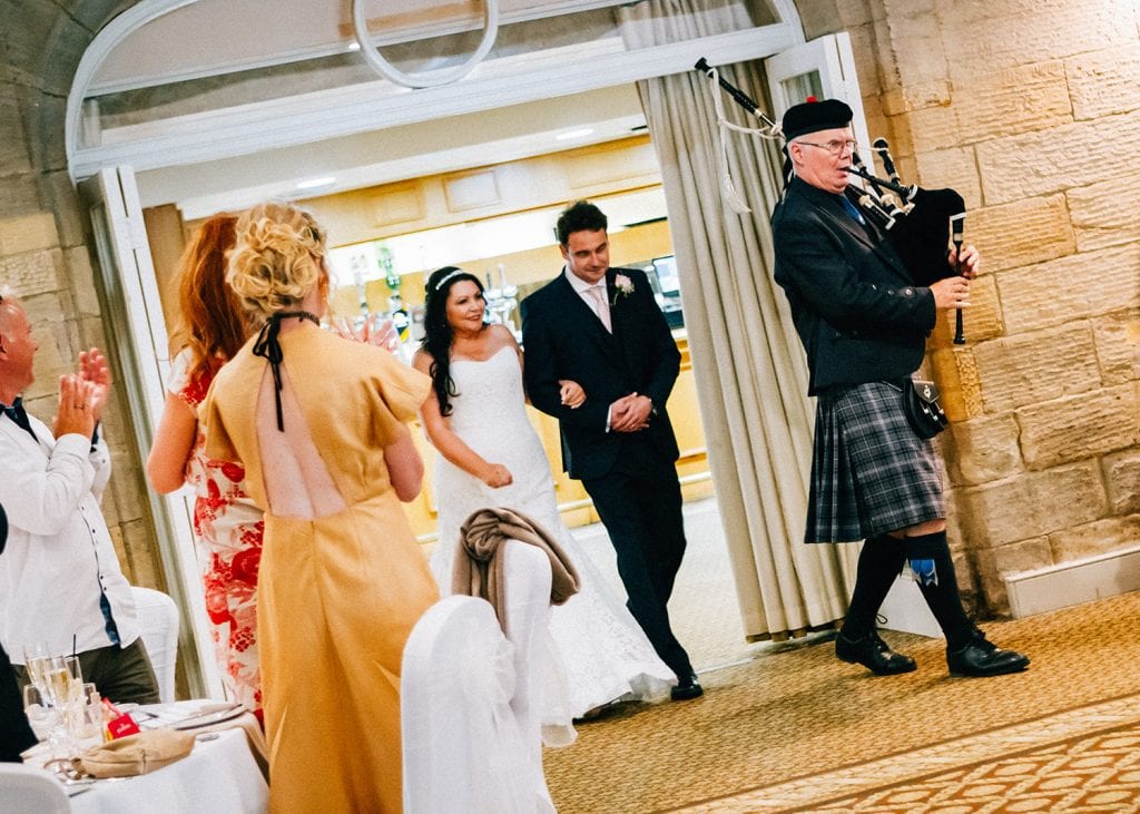 Bride & Groom and pipe player entering the Bigge Room at Linden Hall in Northumberland