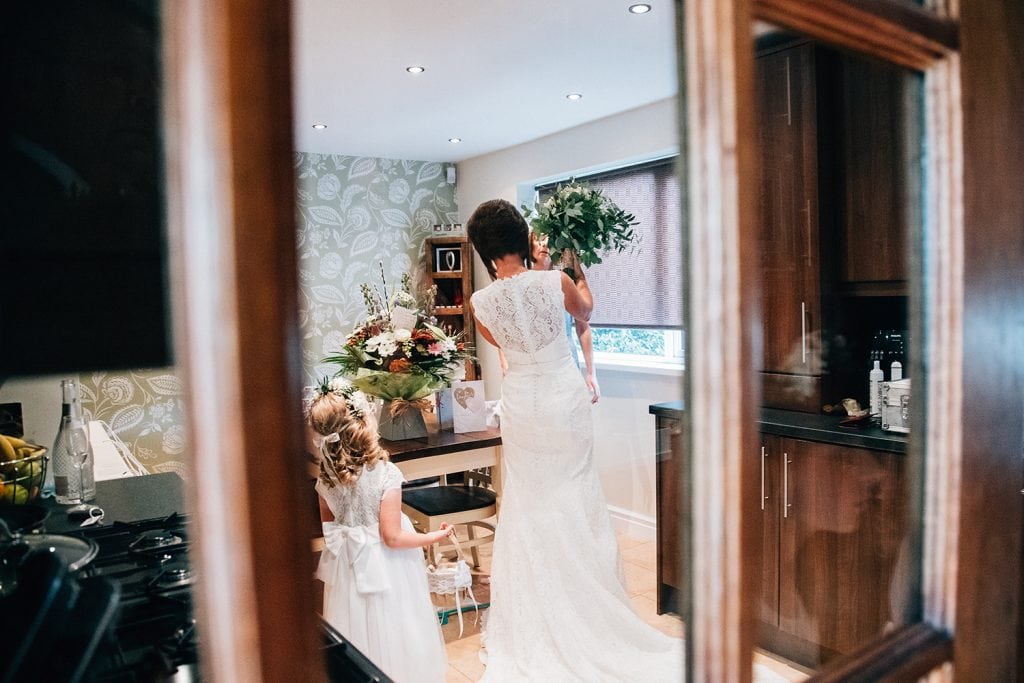 Bride inspecting her bouquet before The Roker Hotel in Sunderland