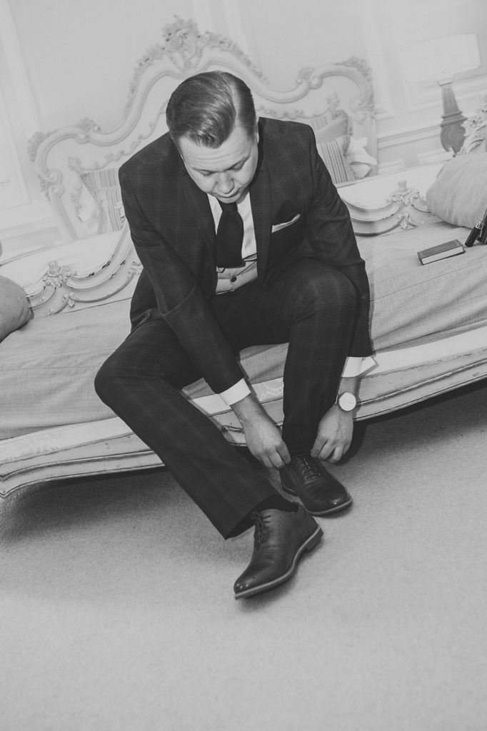 Groom fastening his shoes