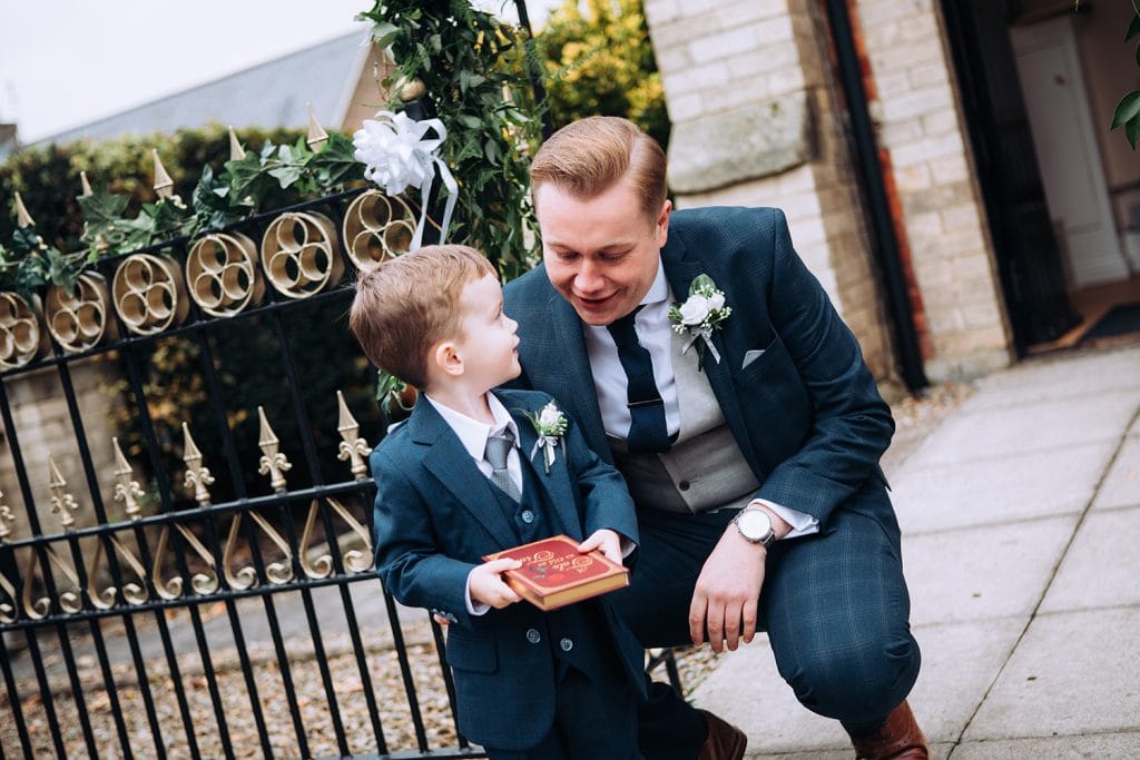 Groom checking his pageboy has the rings outside of the Reading Room in Eshott