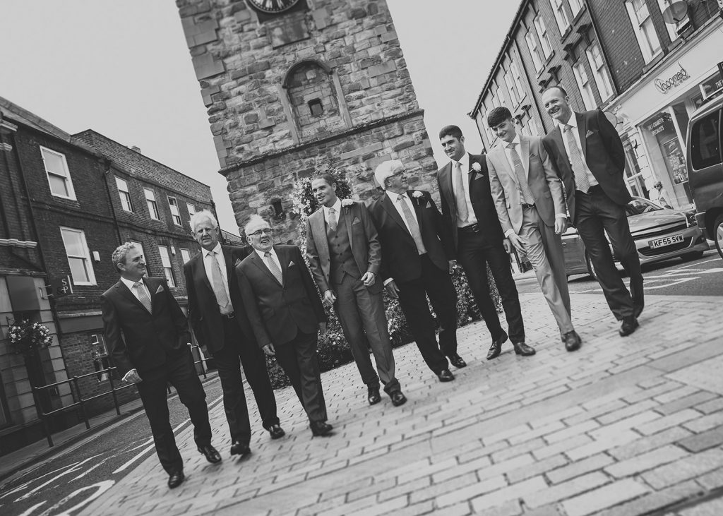 Groom with groomsmen next to Morpeth Clock Tower in Northumberland