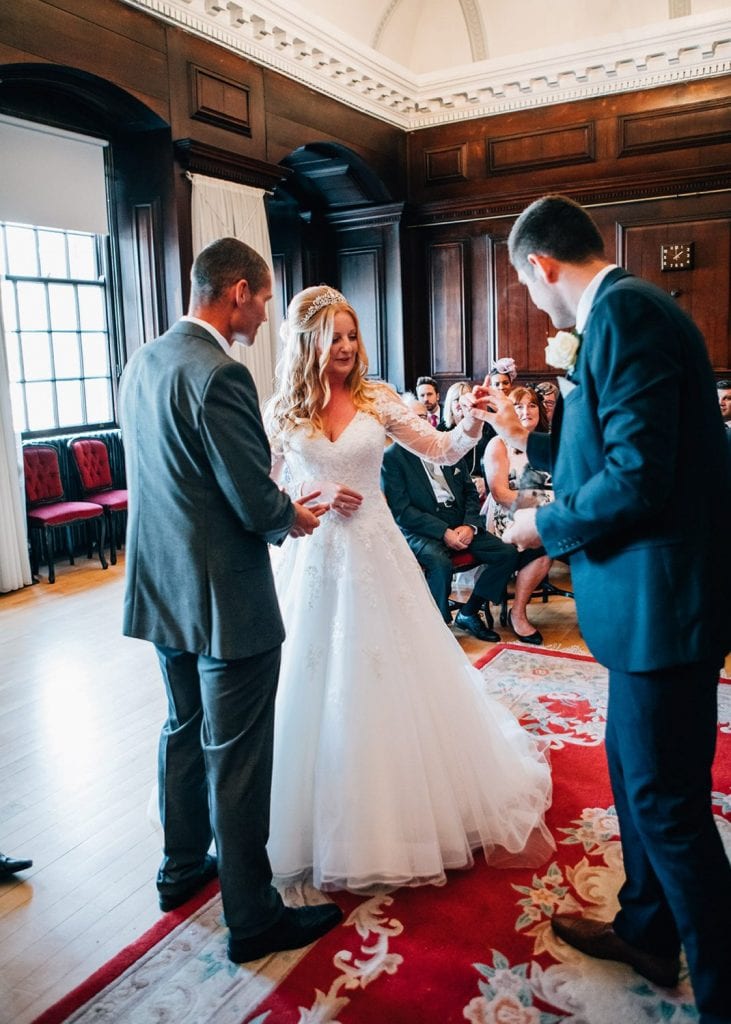 The bride taking her ring from the best man in the The Ballroom, Morpeth Registry Office in Northumberland