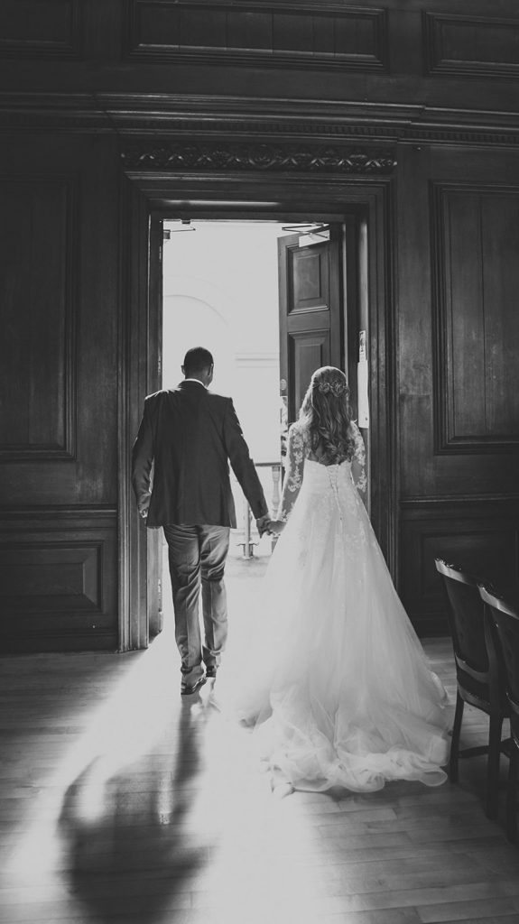 The bride & groom walking out of the Ballroom in Morpeth Registry Office. Northumberland