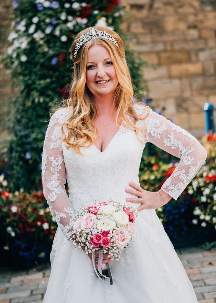 The bride poses infront of the Clock Tower in Morpeth, Northumberland