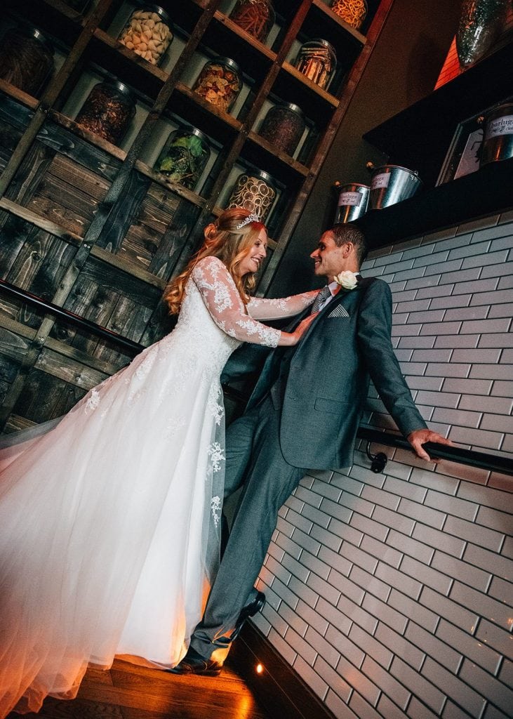 The bride has the groom pinned on the staircase at Barluga in Morpeth, Northumberland