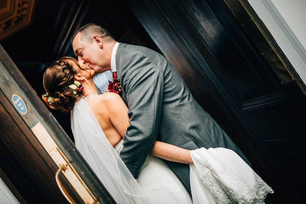 Bride & Groom kissing in the doorway of the Ballroom, Morpeth Town Hall