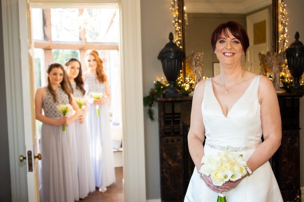 Bridesmaids watching the bride at Ellingham Hall in Northumberland