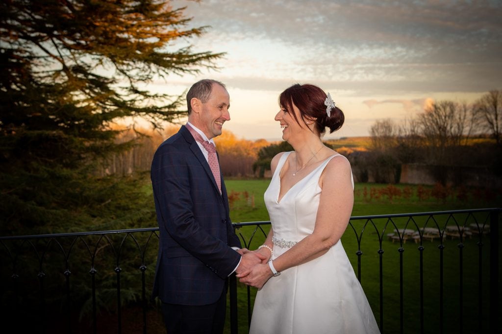 The bride & groom enjoying the sunset at Ellingham Hall in Northumberland