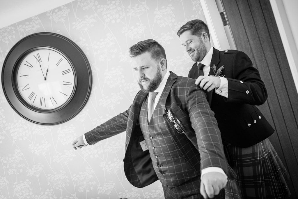 Best man helping groom put his jacket on at a South Shields Wedding