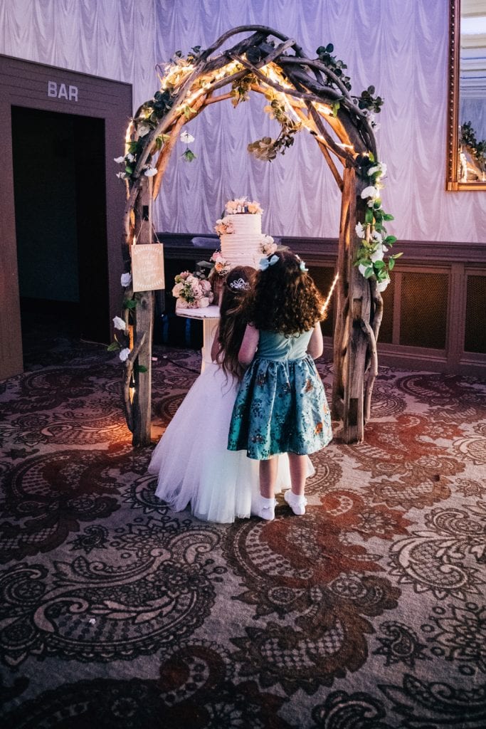 Two Girls looking at Wedding Cake